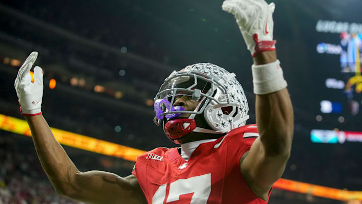 Ohio State Buckeyes wide receiver Carnell Tate (17) celebrates a touchdown Saturday, Dec. 6, 2025, during the Big Ten football championship against the Indiana Hoosiers at Lucas Oil Stadium in Indianapolis.