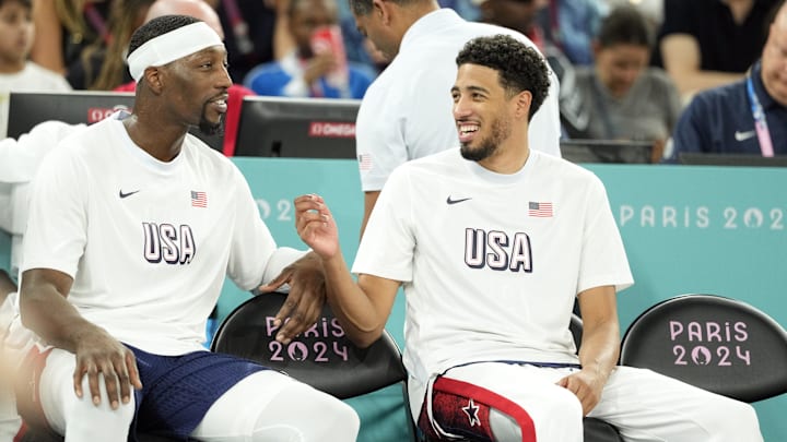 United States centee Bam Adebayo and guard Tyrese Haliburton watch from the sidelines during play at the 2024 Olympics.