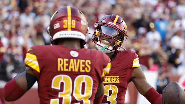 Oct 20, 2024; Landover, Maryland, USA; Washington Commanders cornerback Emmanuel Forbes Jr. (13) celebrates with Commanders safety Jeremy Reaves (39) after intercepting a pass against the Carolina Panthers during the first quarter at Northwest Stadium. Mandatory Credit: Amber Searls-Imagn Images Oct 20, 2024; Landover, Maryland, USA; Washington Commanders cornerback Emmanuel Forbes Jr. (13) celebrates with Commanders safety Jeremy Reaves (39) after intercepting a pass against the Carolina Panthers during the first quarter at Northwest Stadium. Mandatory Credit: Amber Searls-Imagn Images