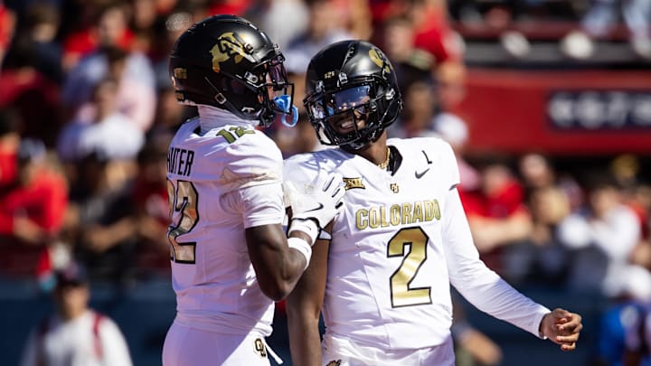 Oct 19, 2024; Tucson, Arizona, USA; Colorado Buffalos quarterback Shedeur Sanders (2) with wide receiver Travis Hunter (12) against the Arizona Wildcats at Arizona Stadium. Mandatory Credit: Mark J. Rebilas-Imagn Images
