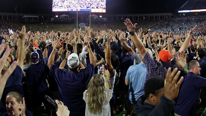Sep 26, 2025; Charlottesville, Virginia, USA; Virginia Cavaliers fans and players celebrate on the field after their game against the Florida State Seminoles at Scott Stadium. Mandatory Credit: Geoff Burke-Imagn Images