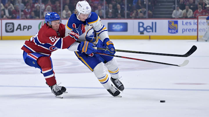 Oct 20, 2025; Montreal, Quebec, CAN; Montreal Canadiens forward Owen Beck (62) and Buffalo Sabres defenseman Rasmus Dahlin (26) battle for the puck during the second period at the Bell Centre. Mandatory Credit: Eric Bolte-Imagn Images