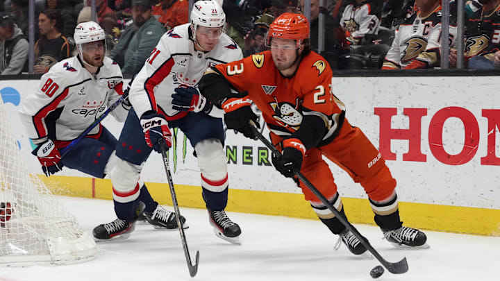 Mar 11, 2025; Anaheim, California, USA; Anaheim Ducks center Mason McTavish (23) skates against Washington Capitals center Aliaksei Protas (21) during the first period at Honda Center. Mandatory Credit: Jason Parkhurst-Imagn Images