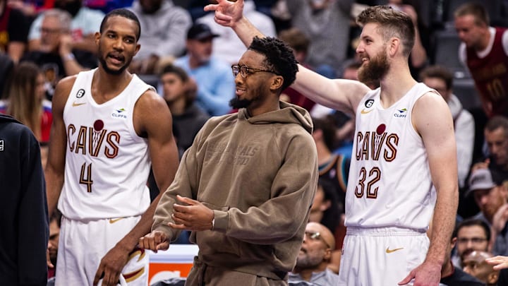 Nov 4, 2022; Detroit, Michigan, USA; Cleveland Cavaliers forward Evan Mobley (4), guard Donovan Mitchell (center) and forward Dean Wade (32) cheer on their team in the second quarter against the Detroit Pistons at Little Caesars Arena. Mandatory Credit: Allison Farrand-Imagn Images