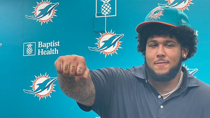 New Miami Dolphins tackle Kadyn Proctor shows off his 1972 tattoo, a tribute to his stepfather