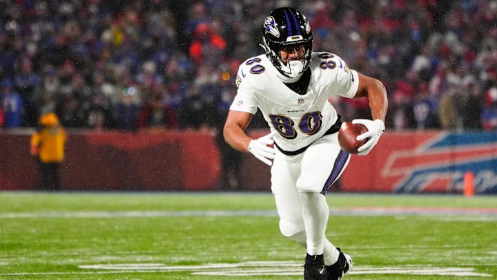 Jan 19, 2025; Orchard Park, New York, USA; Baltimore Ravens tight end Isaiah Likely (80) runs the ball after making a catch during the first quarter against the Buffalo Bills in a 2025 AFC divisional round game at Highmark Stadium.