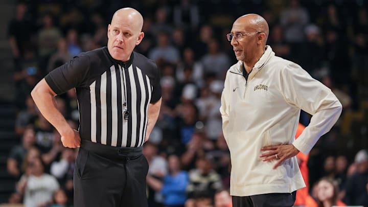 Mar 5, 2025; Orlando, Florida, USA; UCF Knights head coach Johnny Dawkins talks with an official during the first half against the Oklahoma State Cowboys at Addition Financial Arena. Mandatory Credit: Mike Watters-Imagn Images