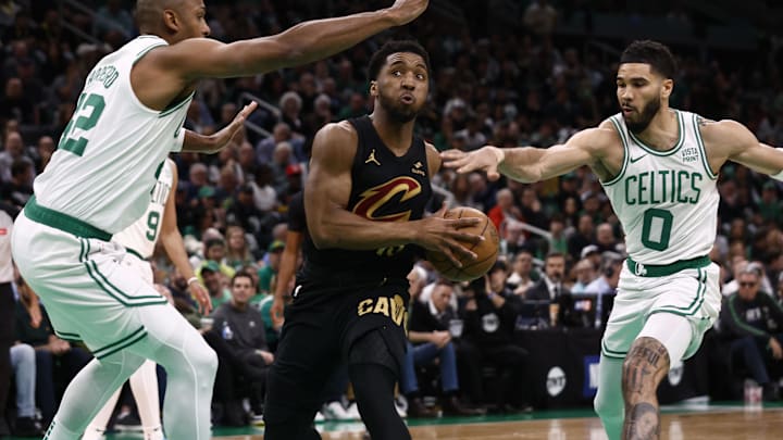 May 7, 2024; Boston, Massachusetts, USA; Cleveland Cavaliers guard Donovan Mitchell (45) tries to get between Boston Celtics forward Jayson Tatum (0) and Al Horford (42) during the first quarter of game one of the second round of the 2024 NBA playoffs at TD Garden. Mandatory Credit: Winslow Townson-Imagn Images