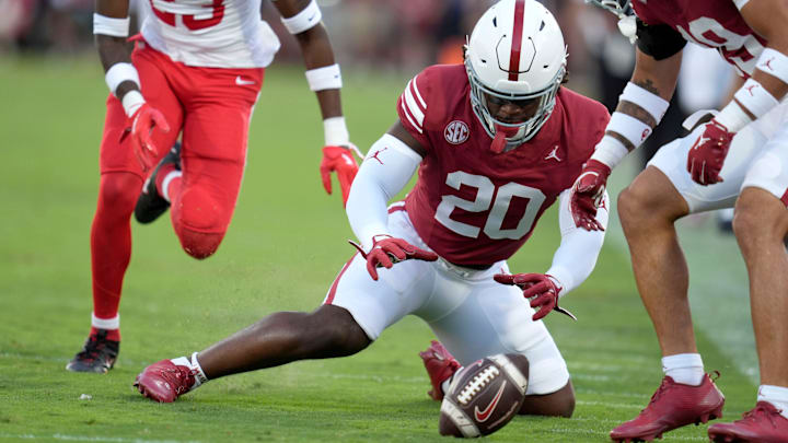 Oklahoma's Lewis Carter (20) recovers a muffed punt against Houston.