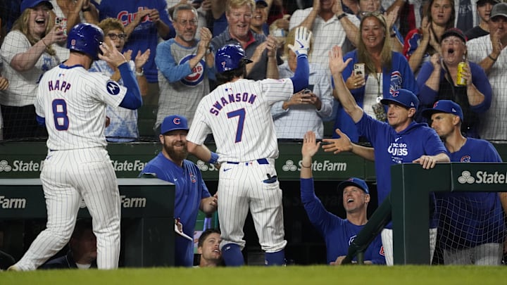 Sep 16, 2024; Chicago, Illinois, USA; Chicago Cubs shortstop Dansby Swanson (7) hits a three-run home run and is greeted by manager Craig Counsell (30) against the Oakland Athletics during the second inning at Wrigley Field. Mandatory Credit: David Banks-Imagn Images