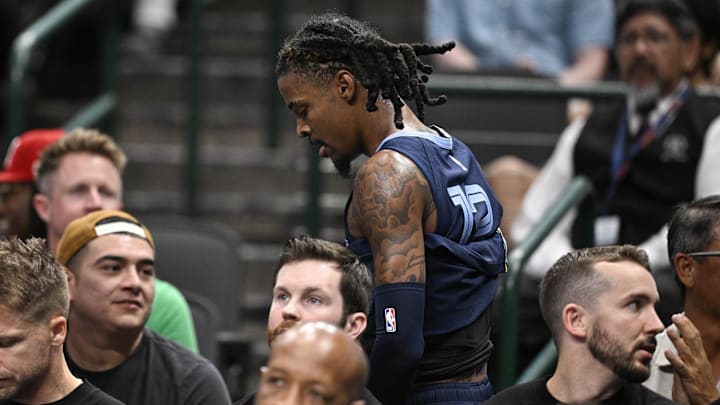 Memphis Grizzlies guard Ja Morant (12) walks off the court after suffering a possible lower body injury during the second quarter against the Dallas Mavericks at the American Airlines Center. Mandatory Credit: Jerome Miron-Imagn Images