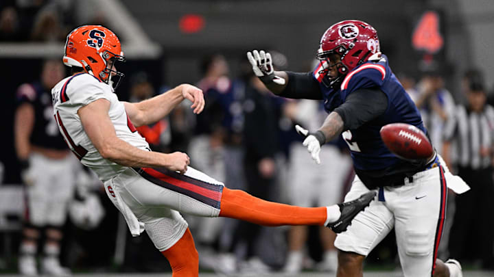 Jan 27, 2026; Frisco, TX, USA; East punter Jack Stonehouse (41) gets off a punt over West defensive lineman Dontay Corleone (2) during the first half at the Ford Center at the Star. Mandatory Credit: Jerome Miron-Imagn Images