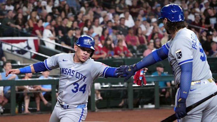 Jul 4, 2025; Phoenix, Arizona, USA; Kansas City Royals catcher Freddy Fermin (34) slaps hands with Kansas City Royals first base Vinnie Pasquantino (9) after scoring a run against the Arizona Diamondbacks during the second inning at Chase Field. Mandatory Credit: Joe Camporeale-Imagn Images