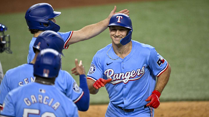 Sep 22, 2024; Arlington, Texas, USA; Texas Rangers left fielder Wyatt Langford (36) celebrates with shortstop Josh Smith (8) and second baseman Marcus Semien (2) and right fielder Adolis Garcia (53) after Langford hits a three run home run against the Seattle Mariners during the sixth inning at Globe Life Field. Mandatory Credit: Jerome Miron-Imagn Images