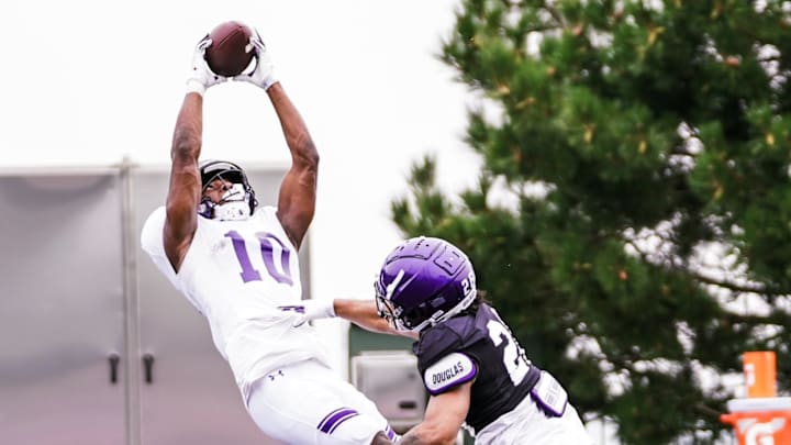 Northwestern wide receiver Ricky Ahumaraeze makes a leaping grab in practice on August 14, 2023.