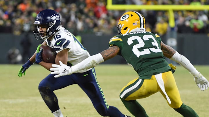 Jan 12, 2020; Green Bay, WI, USA; Seattle Seahawks wide receiver Tyler Lockett (16) runs the ball against Green Bay Packers cornerback Jaire Alexander (23) in the third quarter of a NFC Divisional Round playoff football game at Lambeau Field. Mandatory Credit: Benny Sieu-Imagn Images