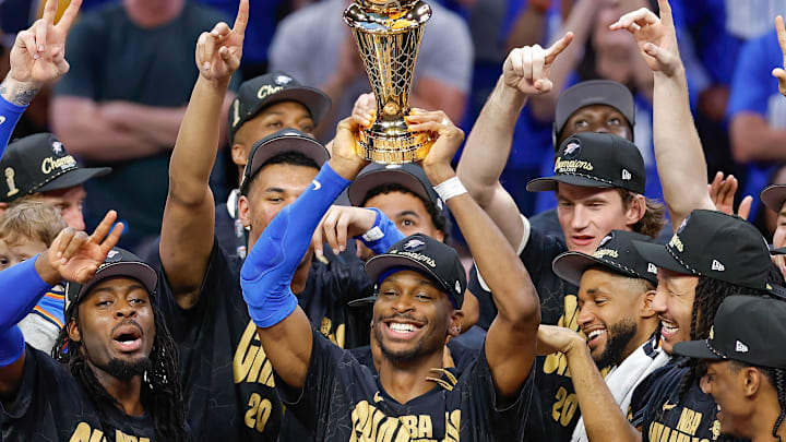 Jun 22, 2025; Oklahoma City, Oklahoma, USA; Oklahoma City Thunder guard Shai Gilgeous-Alexander (2) holds up his NBA Finals Bill Russell MVP trophy at the end of game seven of the 2025 NBA Finals after defeating the Indiana Pacers at Paycom Center. Mandatory Credit: Alonzo Adams-Imagn Images