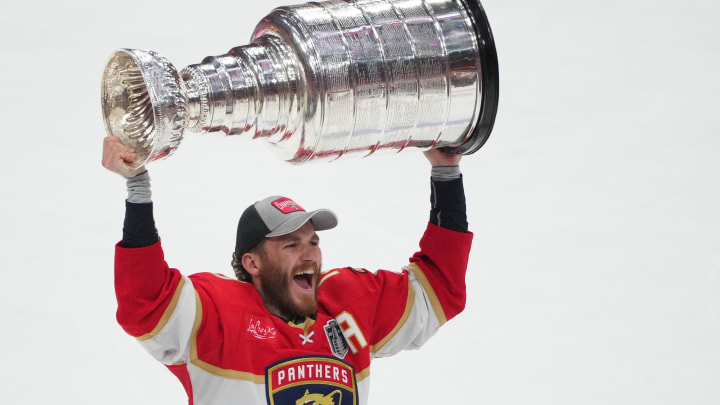 Jun 24, 2024; Sunrise, Florida, USA; Florida Panthers forward Matthew Tkachuk (19) hoists the Stanley Cup after defeating Edmonton Oilers in game seven of the 2024 Stanley Cup Final at Amerant Bank Arena. Mandatory Credit: Jim Rassol-USA TODAY Sports