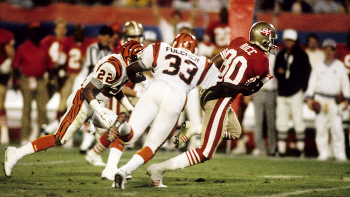Jan 22, 1989; Miami, FL, USA; FILE PHOTO; San Francisco 49ers receiver Jerry Rice (80) carries the ball  against Cincinnati Bengals defenders Eric Thomas (22) and David Fulcher (33) during Super Bowl XXIII at Joe Robbie Stadium. San Francisco defeated Cincinnati  20-16. Mandatory Credit: Manny Rubio-Imagn Images