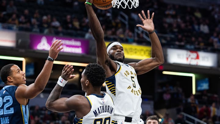 Oct 14, 2024; Indianapolis, Indiana, USA; Indiana Pacers forward Jarace Walker (5) rebounds the ball while Memphis Grizzlies guard Desmond Bane (22) defends in the first quarter at Gainbridge Fieldhouse. Mandatory Credit: Trevor Ruszkowski-Imagn Images