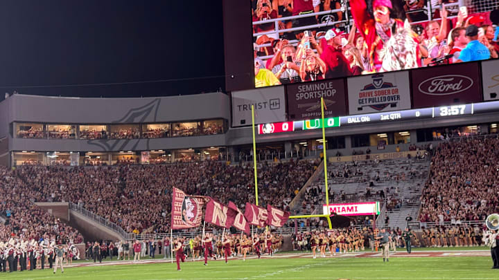 FSU's cheerleaders and football team sprint onto the field at Doak Campbell Stadium for Saturday's showdown against Miami. FSU's cheerleaders and football team sprint onto the field at Doak Campbell Stadium for Saturday's showdown against Miami.