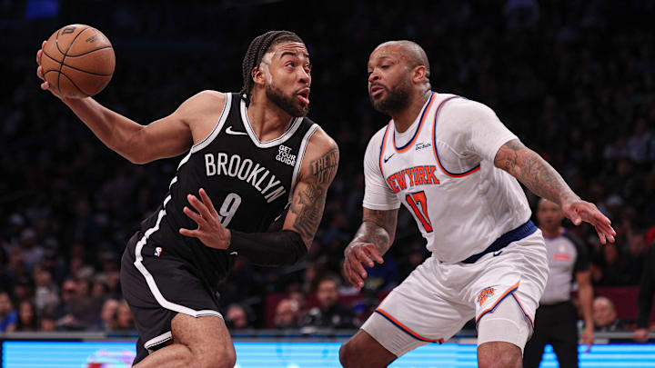 Apr 13, 2025; Brooklyn, New York, USA; Brooklyn Nets forward Trendon Watford (9) goes to the basket after the game New York Knicks forward P.J. Tucker (17) during the second half at Barclays Center. Mandatory Credit: Vincent Carchietta-Imagn Images