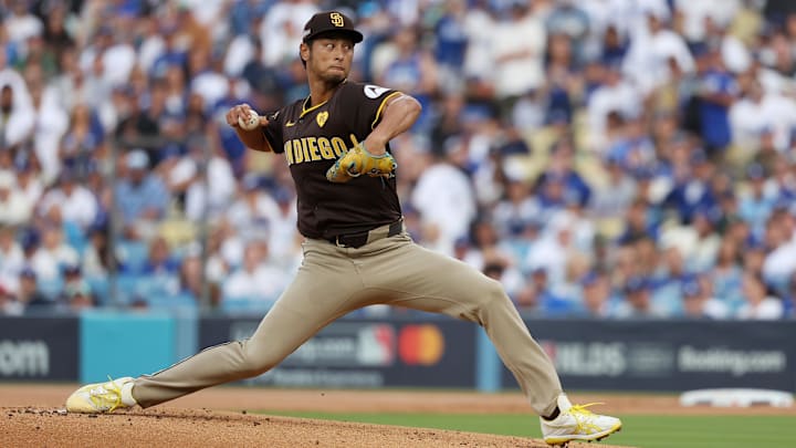 Oct 11, 2024; Los Angeles, California, USA; San Diego Padres pitcher Yu Darvish (11) pitches against the Los Angeles Dodgers in the first inning during game five of the NLDS for the 2024 MLB Playoffs at Dodger Stadium. Mandatory Credit: Kiyoshi Mio-Imagn Images