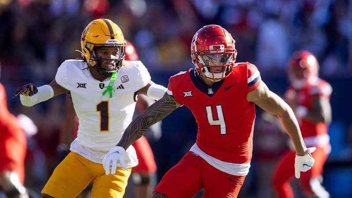 Nov 30, 2024; Tucson, Arizona, USA; Arizona Wildcats wide receiver Tetairoa McMillan (4) against Arizona State Sun Devils defensive back Keith Abney II (1) during the Territorial Cup at Arizona Stadium. 