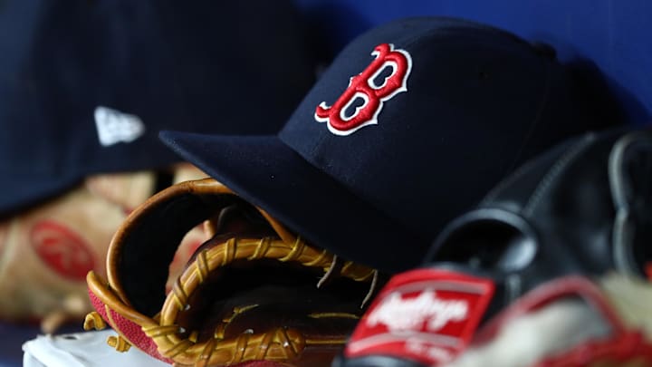 A detail view of Boston Red Sox hats and gloves at Tropicana Field. Mandatory Credit: Kim Klement-Imagn Images