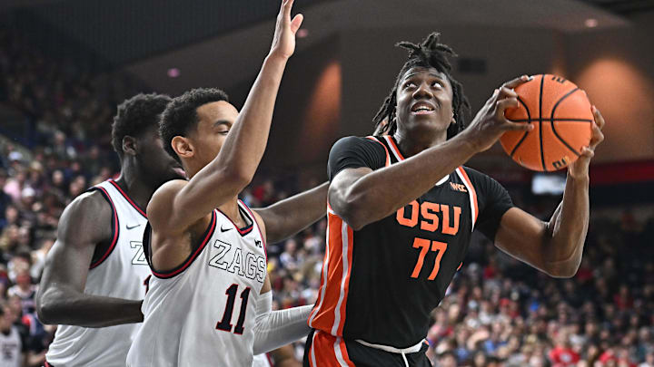 Jan 28, 2025; Spokane, Washington, USA; Oregon State Beavers forward Maxim Logue (77) shoots the ball against Gonzaga Bulldogs guard Nolan Hickman (11) in the second half at McCarthey Athletic Center. Mandatory Credit: James Snook-Imagn Images