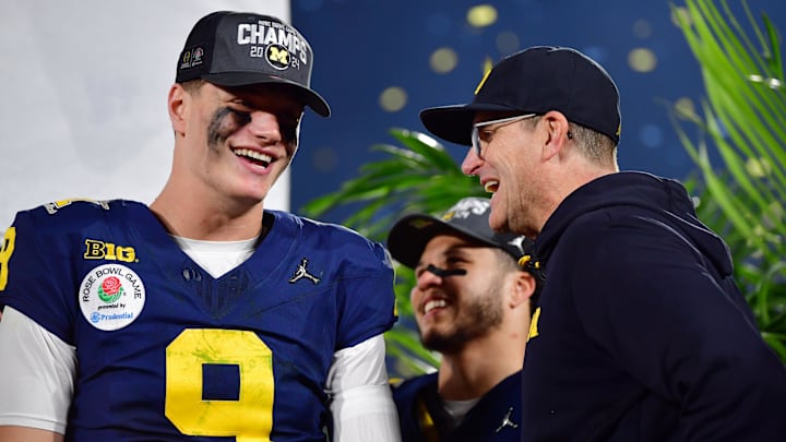 Michigan Wolverines head coach Jim Harbaugh and quarterback J.J. McCarthy celebrate on the podium after defeating the Alabama Crimson Tide in the 2024 Rose Bowl college football playoff semifinal game at Rose Bowl. 