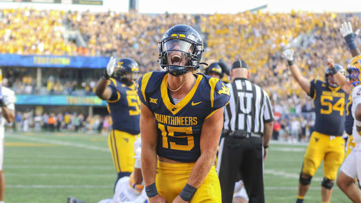 Sep 13, 2025; Morgantown, West Virginia, USA; West Virginia Mountaineers quarterback Scotty Fox Jr. (15) celebrates after a touchdown during the third quarter against the Pittsburgh Panthers at Milan Puskar Stadium. Mandatory Credit: Ben Queen-Imagn Images