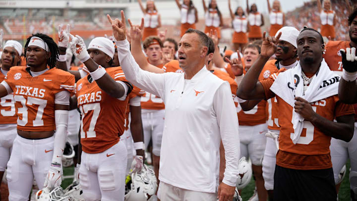 Sep 6, 2025; Austin, Texas, USA; Texas Longhorns head coach Steve Sarkisian and players hold up their horns with the fans during the singing of the Eyes of Texas after a victory over the San Jose State Spartans at Darrell K Royal-Texas Memorial Stadium. Mandatory Credit: Scott Wachter-Imagn Images