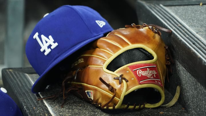Apr 28, 2024; Toronto, Ontario, CAN; A hat and glove of an Los Angeles Dodgers player durng a game against the Toronto Blue Jays at Rogers Centre. Mandatory Credit: John E. Sokolowski-Imagn Images Apr 28, 2024; Toronto, Ontario, CAN; A hat and glove of an Los Angeles Dodgers player durng a game against the Toronto Blue Jays at Rogers Centre. Mandatory Credit: John E. Sokolowski-Imagn Images