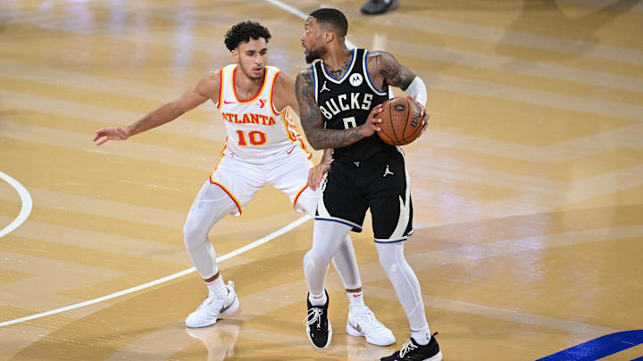 Dec 14, 2024; Las Vegas, Nevada, USA; Milwaukee Bucks guard Damian Lillard (0) controls the ball against Atlanta Hawks forward Zaccharie Risacher (10) during the third quarter in a semifinal of the 2024 Emirates NBA Cup at T-Mobile Arena. Mandatory Credit: Candice Ward-Imagn Images