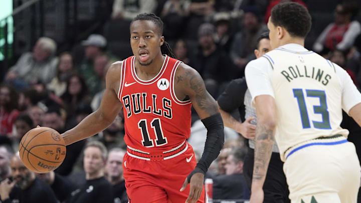 Feb 3, 2026; Milwaukee, Wisconsin, USA; Chicago Bulls guard Ayo Dosunmu (11) dribbles the ball against Milwaukee Bucks guard Ryan Rollins (13) in the first half at Fiserv Forum.