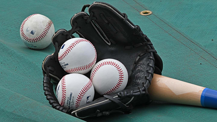 Jun 27, 2024; Kansas City, Missouri, USA; A general view of a glove, baseballs and a bat before a game between the Kansas City Royals and Cleveland Guardians at Kauffman Stadium. Mandatory Credit: Peter Aiken-Imagn Images Jun 27, 2024; Kansas City, Missouri, USA; A general view of a glove, baseballs and a bat before a game between the Kansas City Royals and Cleveland Guardians at Kauffman Stadium. Mandatory Credit: Peter Aiken-Imagn Images