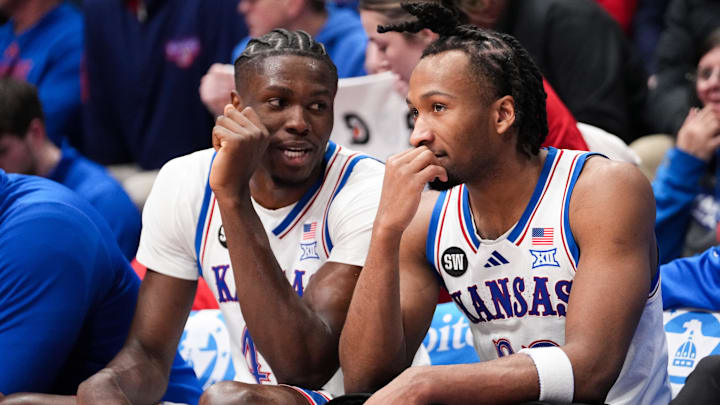 Jan 16, 2026; Lawrence, Kansas, USA; Kansas Jayhawks forward Flory Bidunga (40) and guard Darryn Peterson (22) talk on the bench against the Baylor Bears