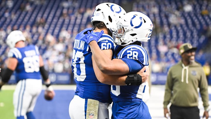 Oct 26, 2025; Indianapolis, Indiana, USA; Indianapolis Colts running back Jonathan Taylor (28) and Indianapolis Colts center Tanor Bortolini (60) warm up before the game against the Tennessee Titans at Lucas Oil Stadium. Mandatory Credit: Robert Goddin-Imagn Images