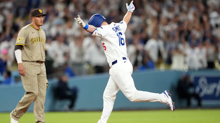 Jun 18, 2025; Los Angeles, California, USA; Los Angeles Dodgers catcher Will Smith (16) runs the bases after hitting a walkoff home run as San Diego Padres third baseman Manny Machado (13) watches at Dodger Stadium. Mandatory Credit: Kirby Lee-Imagn Images