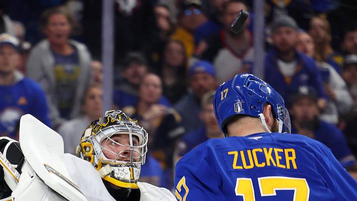 Apr 28, 2026; Buffalo, New York, USA; Buffalo Sabres left wing Jason Zucker (17) looks for the puck as Boston Bruins goaltender Jeremy Swayman (1) looks to knock it out of the air during the second period in game five of the first round of the 2026 Stanley Cup Playoffs at KeyBank Center. Mandatory Credit: Timothy T. Ludwig-Imagn Images