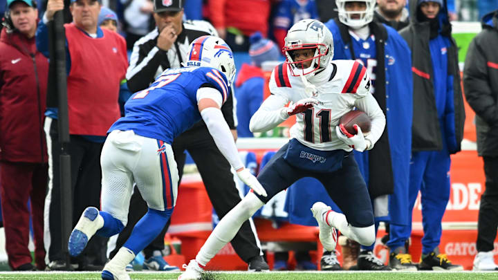 Dec 31, 2023; Orchard Park, New York, USA; New England Patriots wide receiver Tyquan Thornton (11) tries to move past Buffalo Bills cornerback Taron Johnson (7) after making a catch in the third quarter at Highmark Stadium. Mandatory Credit: Mark Konezny-Imagn Images