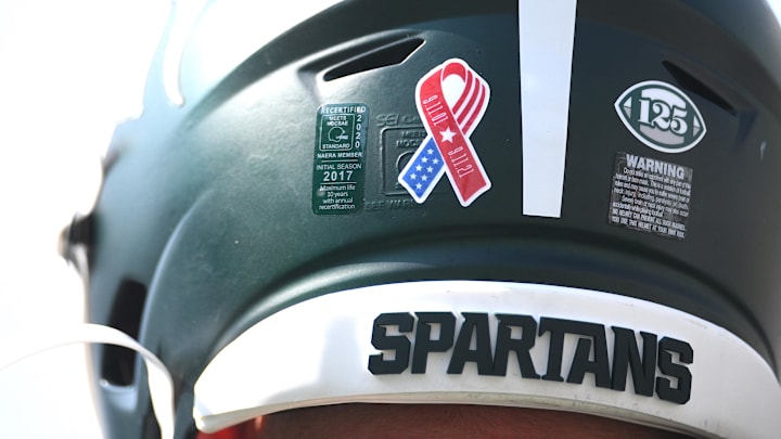 Sep 11, 2021; East Lansing, Michigan, USA; A detail view of a Michigan State Spartans helmet before the game against the Youngstown State Penguins at Spartan Stadium. Mandatory Credit: Tim Fuller-USA TODAY Sports Sep 11, 2021; East Lansing, Michigan, USA; A detail view of a Michigan State Spartans helmet before the game against the Youngstown State Penguins at Spartan Stadium. Mandatory Credit: Tim Fuller-USA TODAY Sports