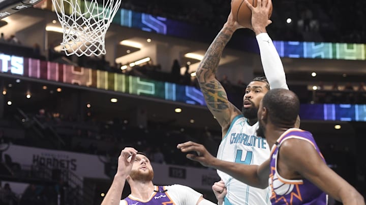 Jan 7, 2025; Charlotte, North Carolina, USA;  Charlotte Hornets center Nick Richards (4) looks to pass a rebound during the first half against the Phoenix Suns at the Spectrum Center. Mandatory Credit: Sam Sharpe-Imagn Images