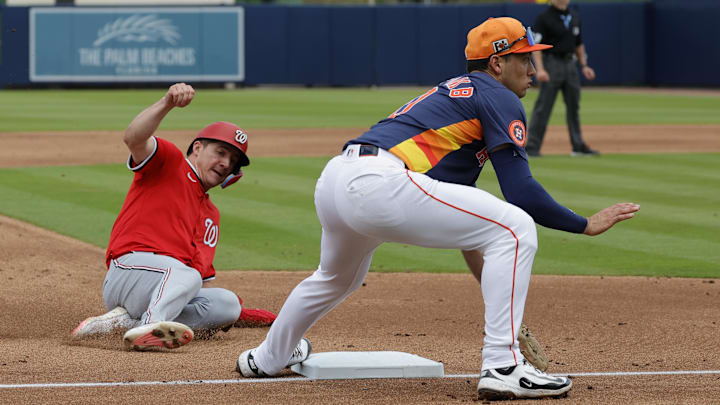 Feb 22, 2025; West Palm Beach, Florida, USA; Washington Nationals outfielder Jacob Young (30) steals third base as Houston Astros shortstop Shay Whitcomb (right) waits on then ball in the third inning at CACTI Park of the Palm Beaches.