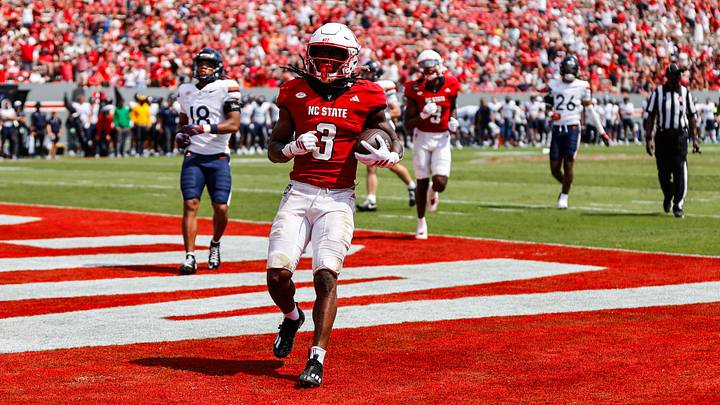 Texas Longhorns running back Hollywood Smothers runs with the football to score a touchdown as a member of the NC State Wolfpack during the second half of the game against the Virginia Cavaliers