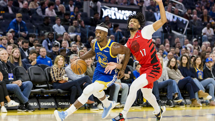 Mar 10, 2025; San Francisco, California, USA; Golden State Warriors forward Jimmy Butler III (10) drives past Portland Trail Blazers guard Shaedon Sharpe (17) during the second quarter at Chase Center. Mandatory Credit: John Hefti-Imagn Images