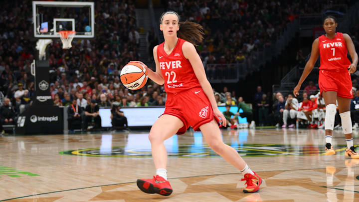 Jun 24, 2025; Seattle, Washington, USA; Indiana Fever guard Caitlin Clark (22) dribbles the ball against the Seattle Storm during the second half at Climate Pledge Arena. Mandatory Credit: Steven Bisig-Imagn Images