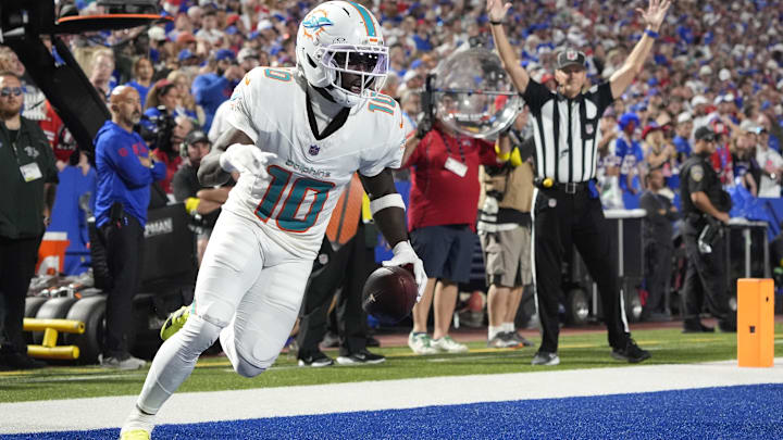 Sep 18, 2025; Orchard Park, New York, USA;  Miami Dolphins wide receiver Tyreek Hill (10) scores a touchdown against the Buffalo Bills in the fourth quarter at Highmark Stadium. Mandatory Credit: Gregory Fisher-Imagn Images