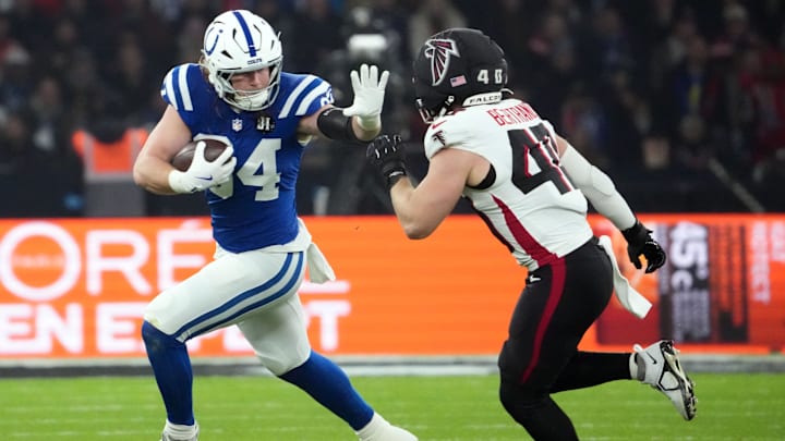 Nov 9, 2025; Berlin, Germany; Indianapolis Colts tight end Tyler Warren (84) runs against Atlanta Falcons linebacker JD Bertrand (40) during the NFL Berlin Game at Olympic Stadium. Mandatory Credit: Kirby Lee-Imagn Images